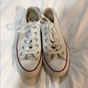 White Converse lace up sneakers.